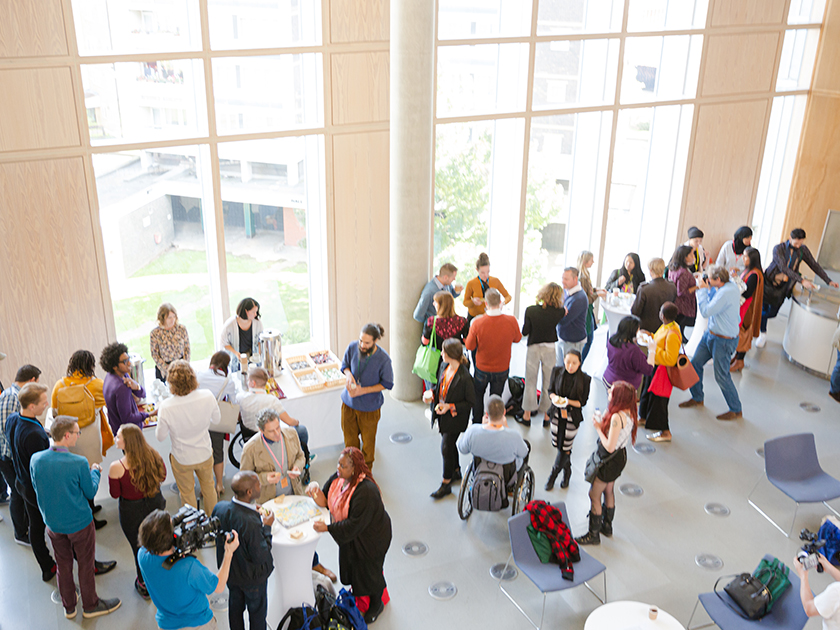 An aerial view of a ballroom with conference attendees mingling