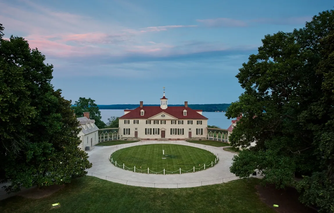 Image of Mount Vernon with the circular driveway in front overlooking the water behind the house